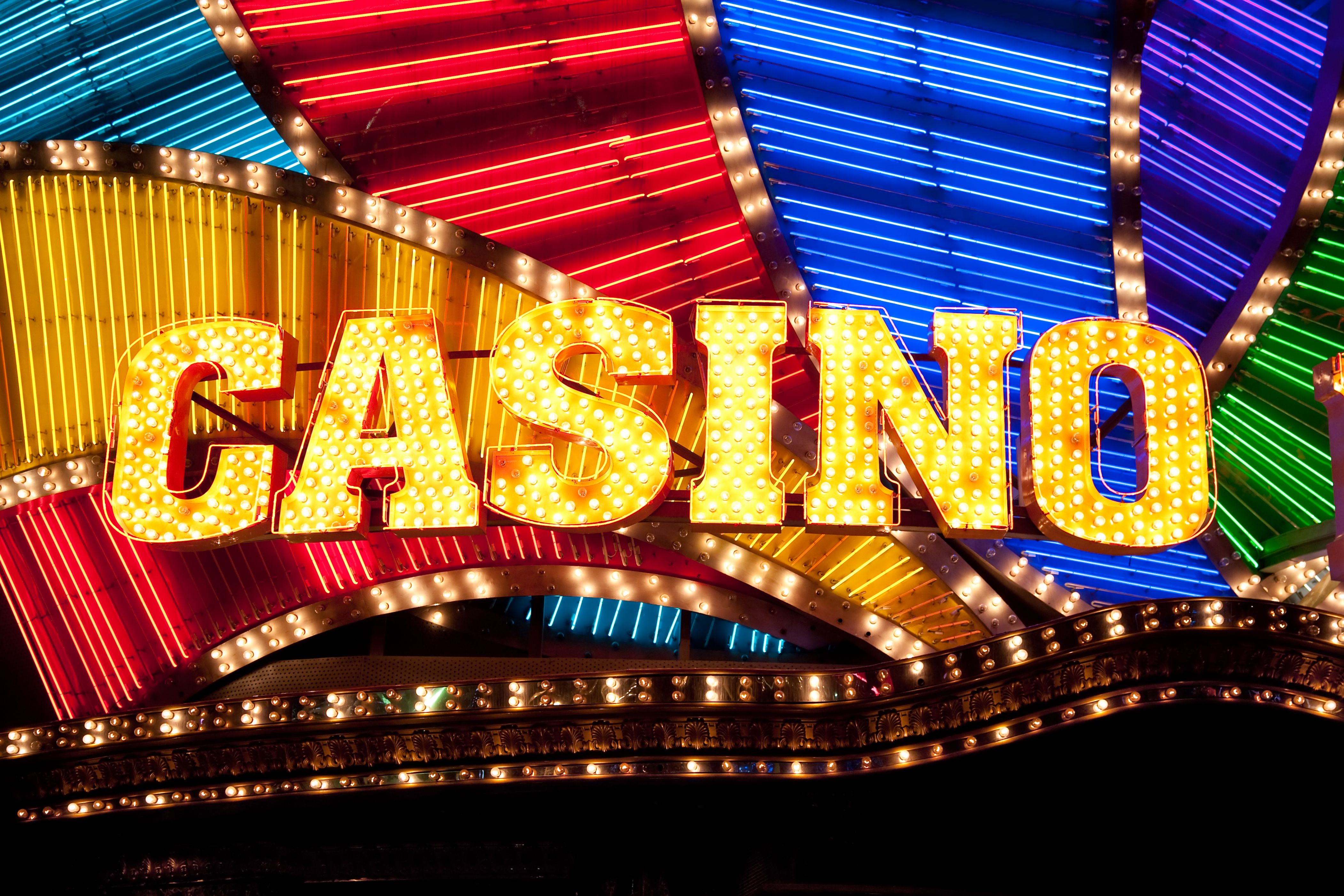 A graphic showcasing the Wild Casino logo with the text 'BONUS CODES' and images of coins and cards.